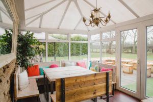 Empty room shot of a cosy looking conservatory.